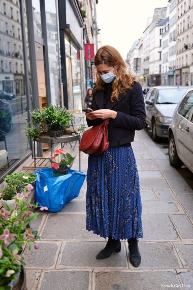 French style - a woman wearing a blue pleated skirt by Caroll in Paris, France during the lockdown